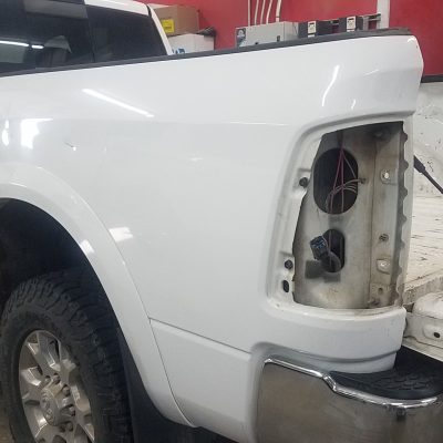 White Sierra pickup truck dented from collision