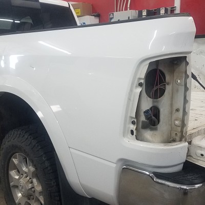 White Sierra pickup truck dented from collision