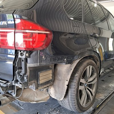 Repairing a damaged black SUV rear bumper