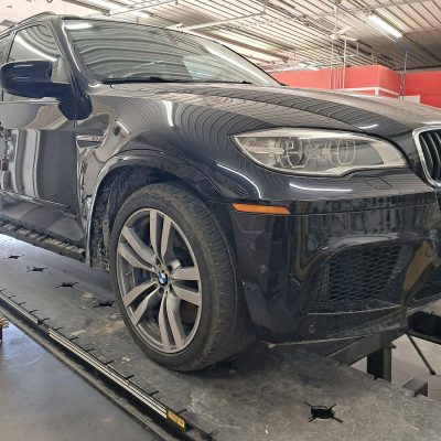 Black SUV up on car lift