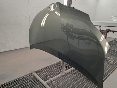 Newly repaired and painted front hood of a vehicle